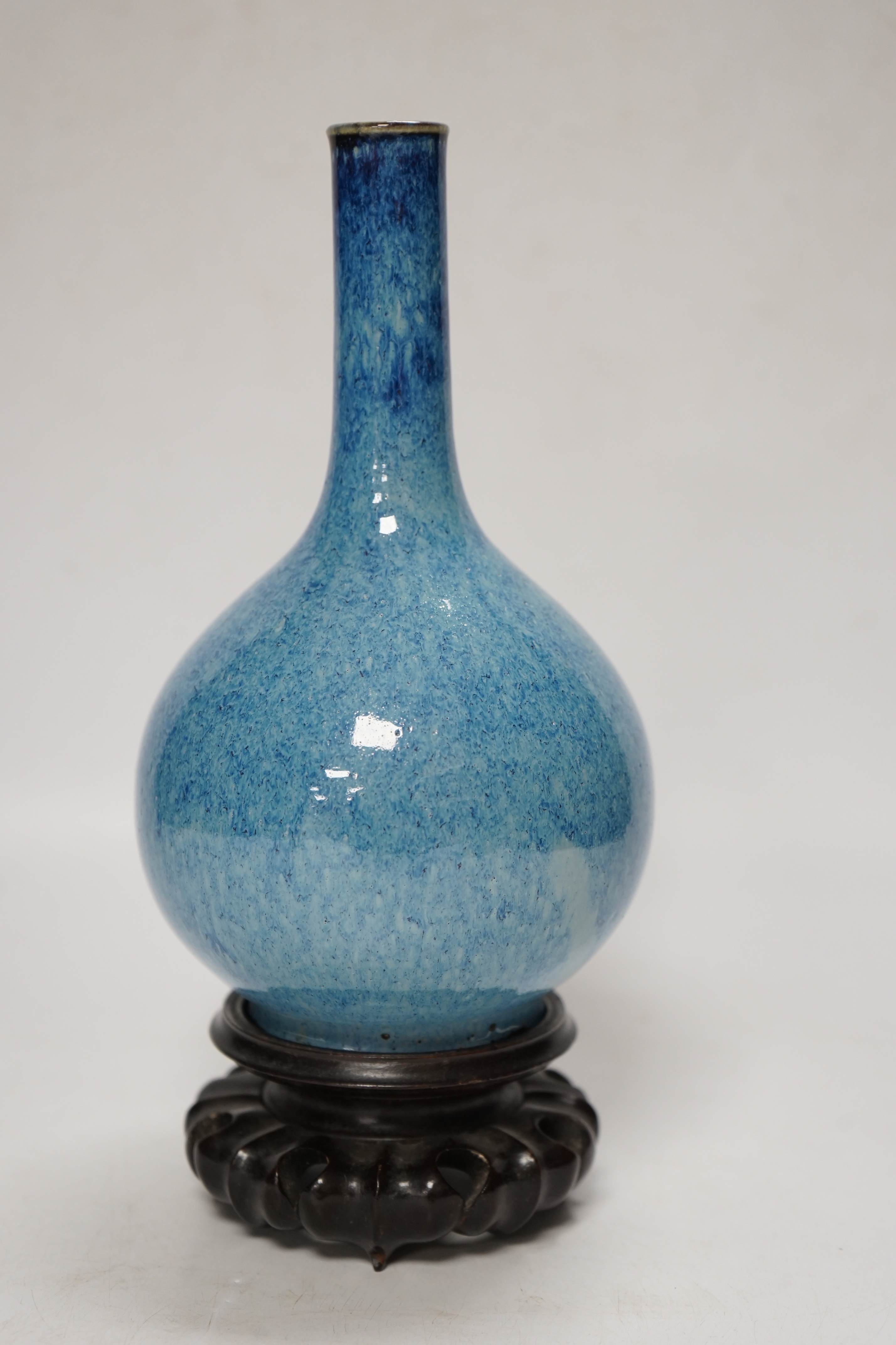 A Chinese blue flambe bottle vase, on stand, 22cm